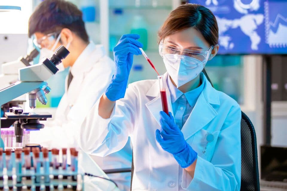 Scientists handling a blood sample in the laboratory